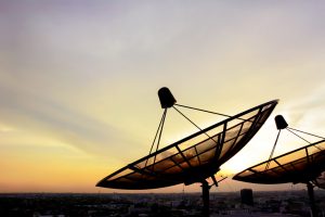 Satellite dishes on twilight sky background